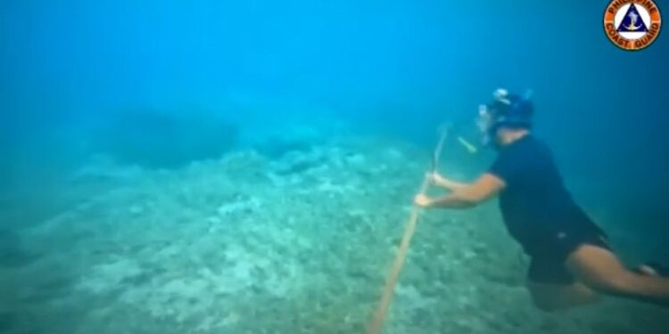 Filipino diver with a knife helps remove floating barrier installed by China in South China Sea | CNN